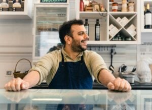 Person in apron at counter