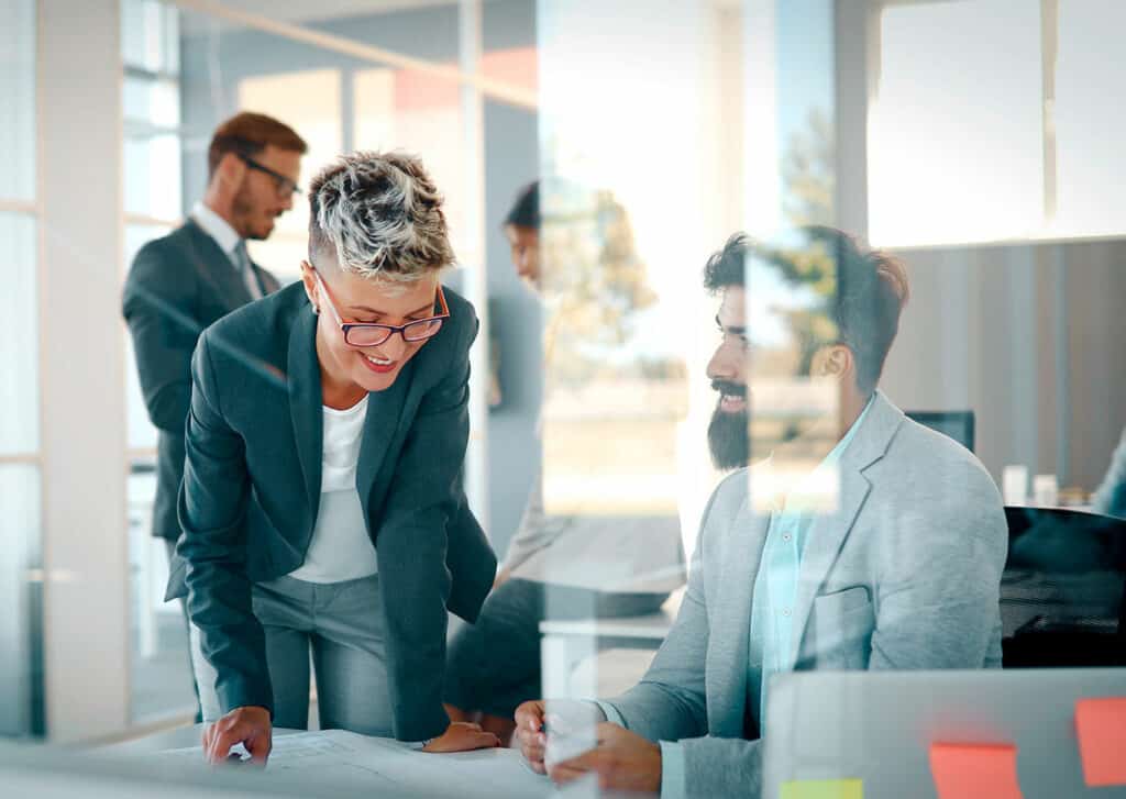 Woman and man talking in office environment