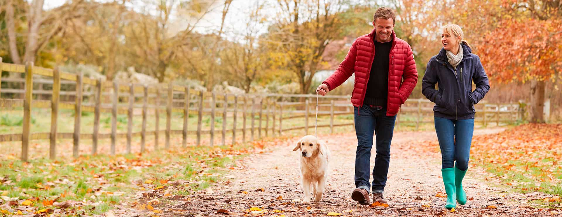 Man and lady walking dog