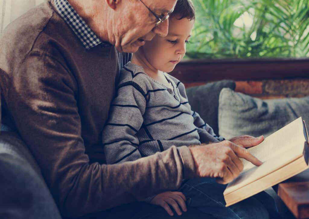 Grandad reading with child