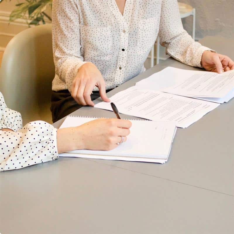 Documents on a desk, making notes