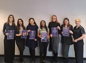 Group of ladies holding IWD posters